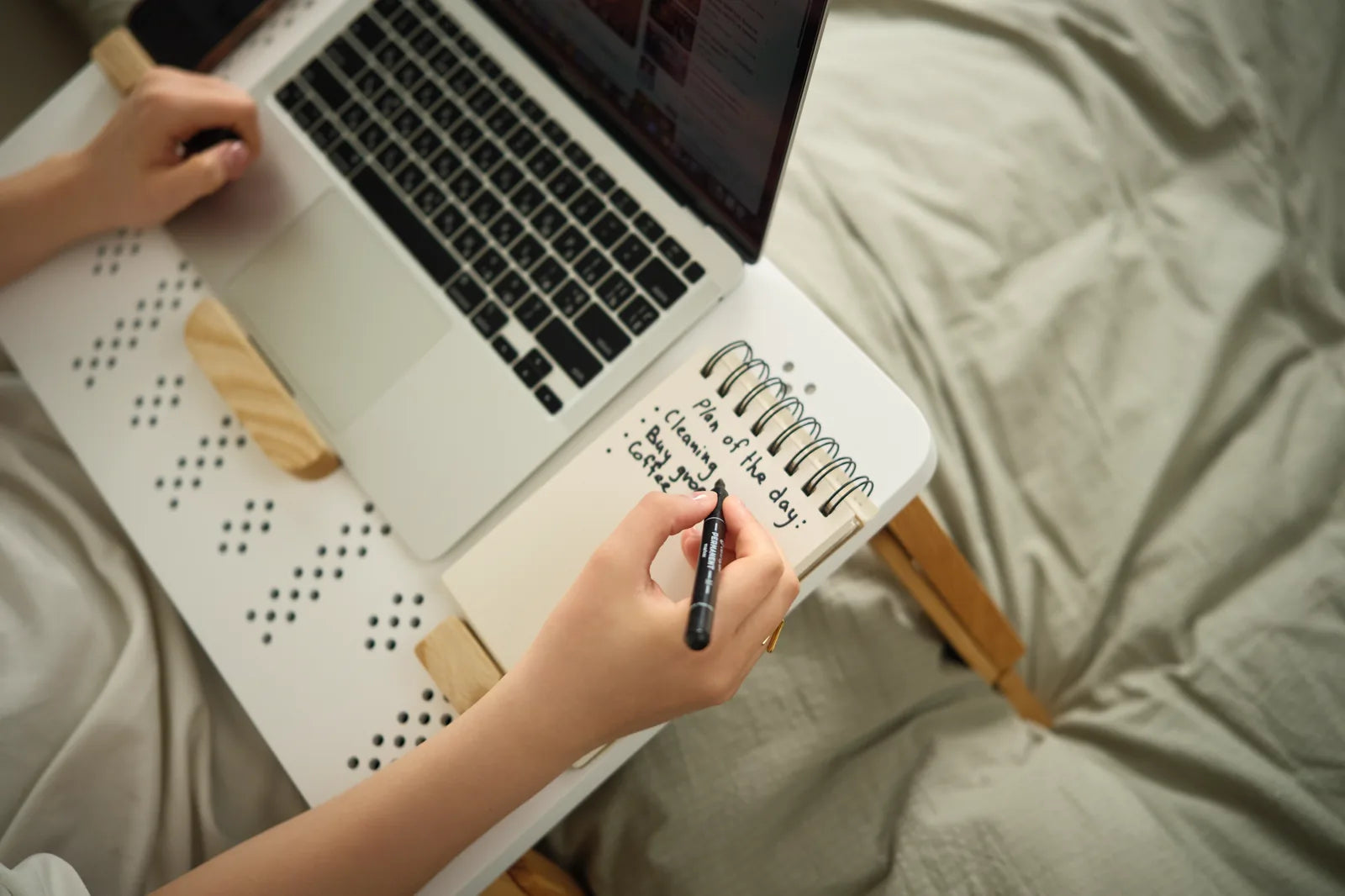 Planning the day in a notebook while working from bed with TablePro.