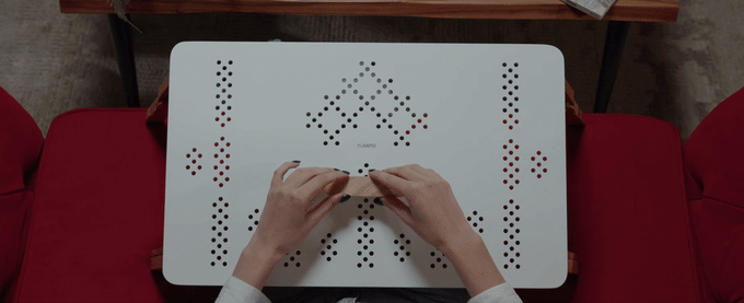 Animated demonstration of wooden modules being fitted into the perforated TablePro top.