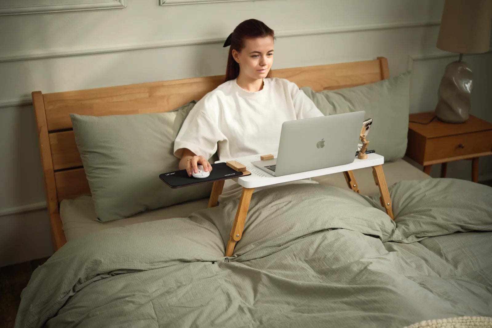 TablePro with a laptop, phone holder and mouse module used in bed.