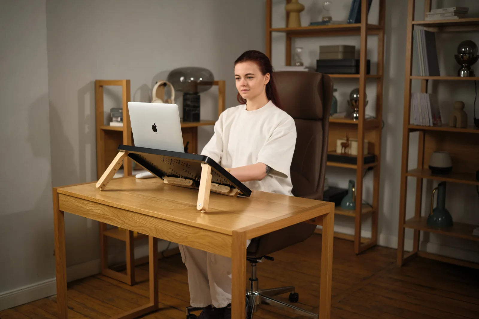 Working seated at a regular desk with the laptop raised on TablePro.