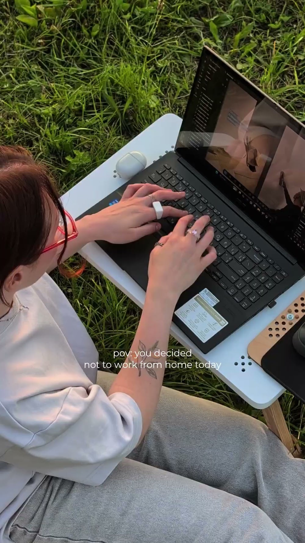 Customer using a white TablePro with a laptop outdoors.
