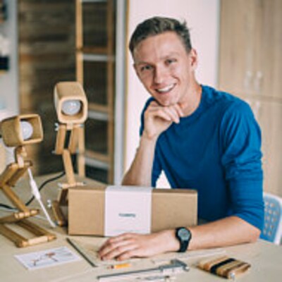 Flampic founder Vasyl Nikolaienko in the workshop with wooden products.